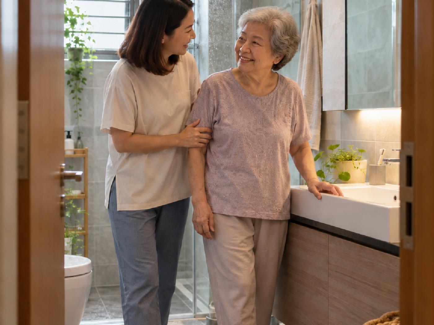 Young homeowner supporting an older parent in a modern home bathroom